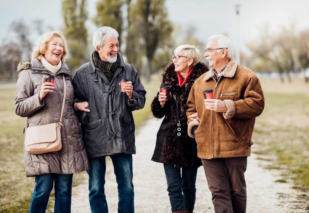 Two older couples laughing together